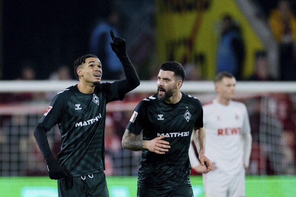 Bundesliga fan protests with tennis balls and toy cars interrupt